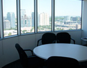 A table and chairs in front of a window.